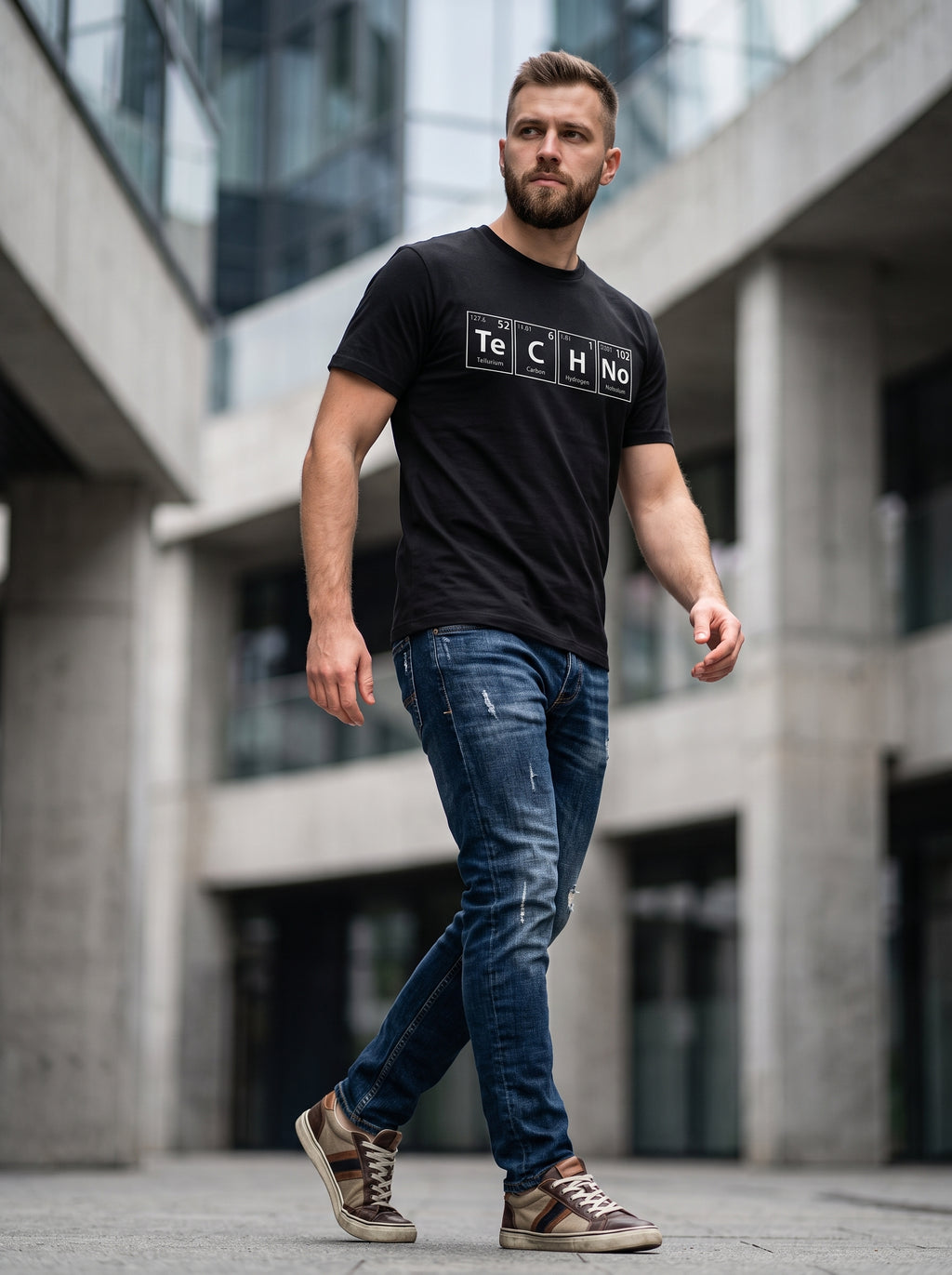 TeCHNo Elements Tee — black t-shirt with periodic table TECHNO print worn by man on urban street