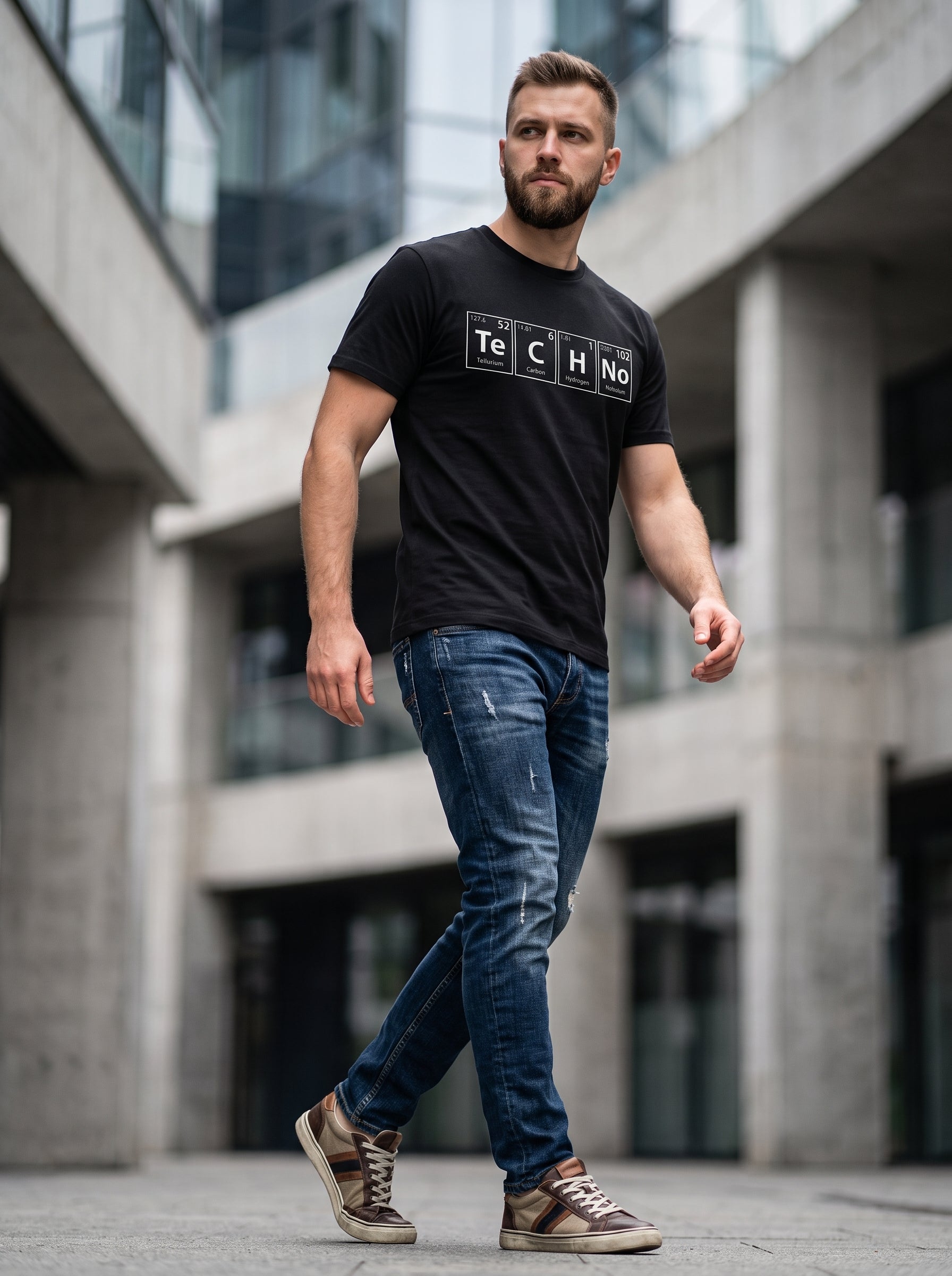 TeCHNo Elements Tee — black t-shirt with periodic table TECHNO print worn by man on urban street