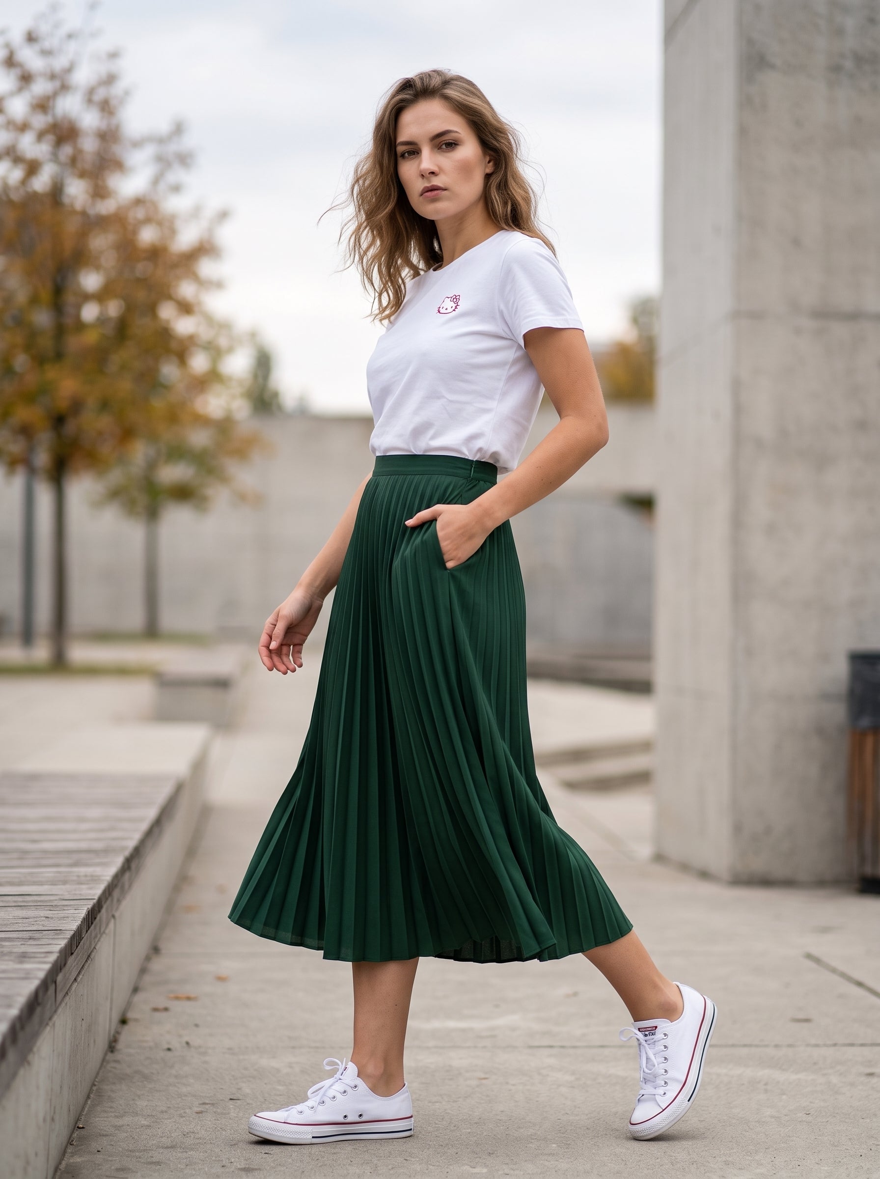 Forest Green Pleated Midi Skirt — worn by woman walking outdoors with white tee and sneakers