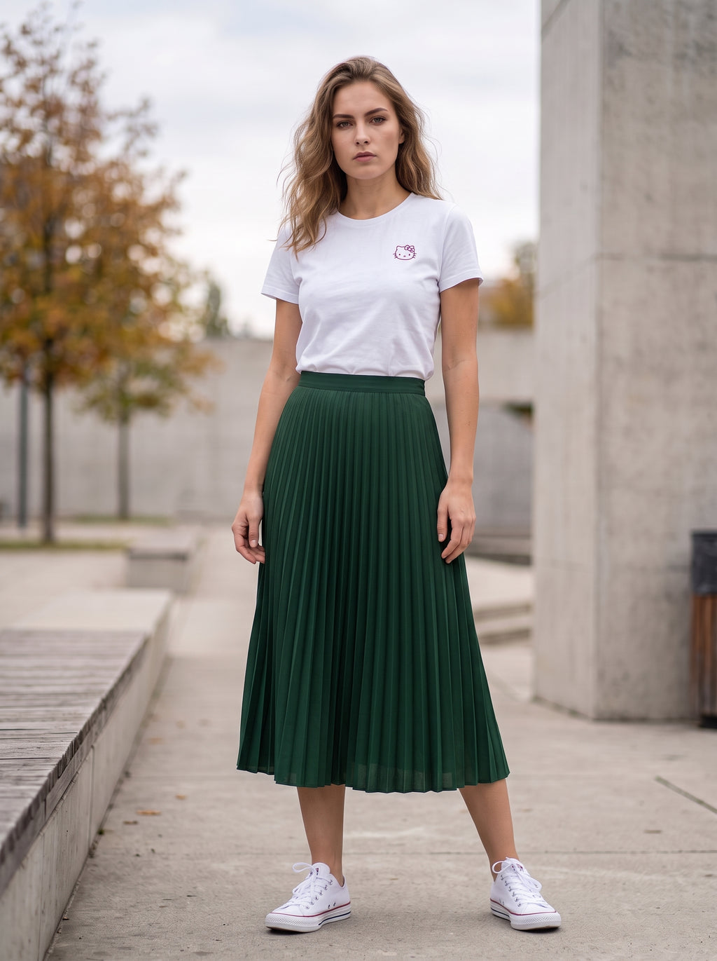 Forest Green Pleated Midi Skirt — front view worn by woman outdoors