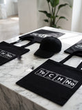 TeCHNo Tote Bag — black canvas tote with periodic table TECHNO print