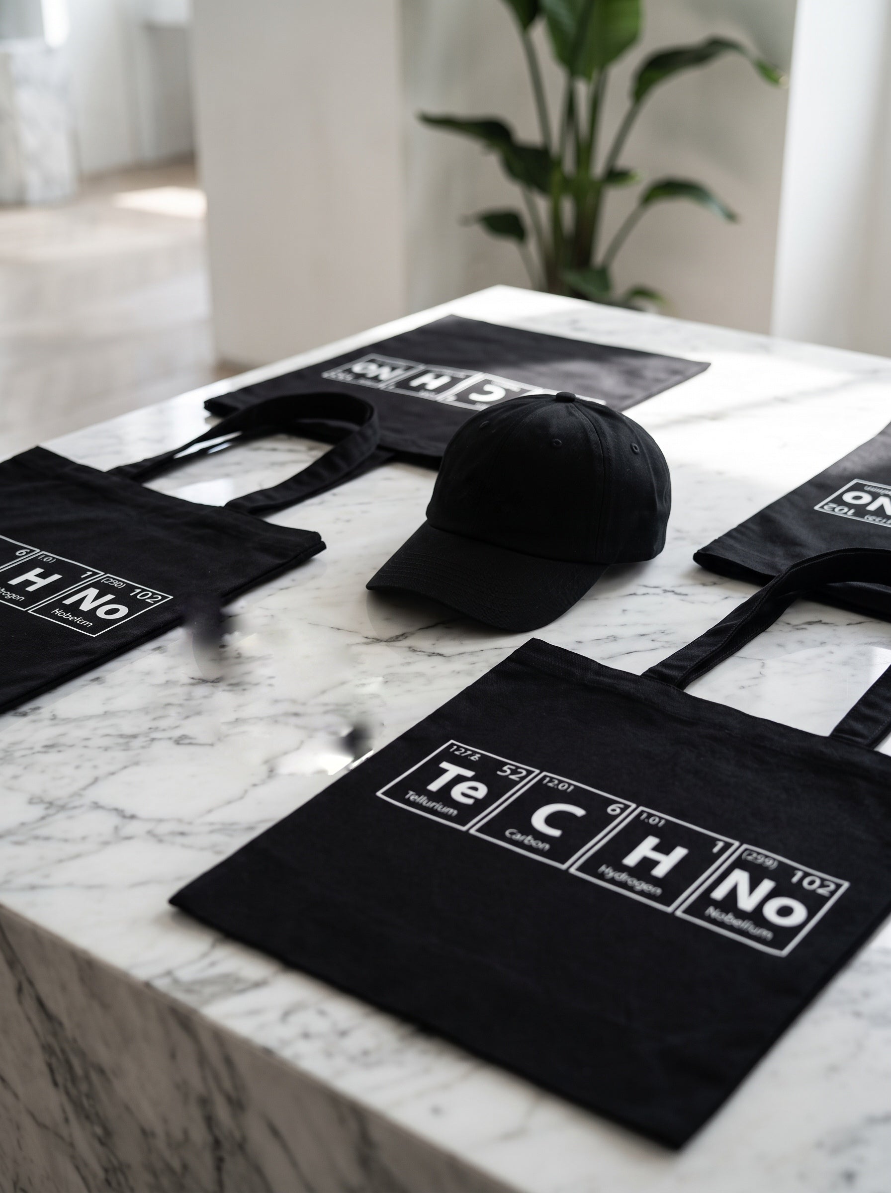 TeCHNo Tote Bag — black canvas tote with periodic table TECHNO print