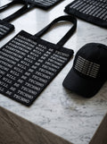Everything Will Be Techno Tote Bag — black canvas tote with all-over text print