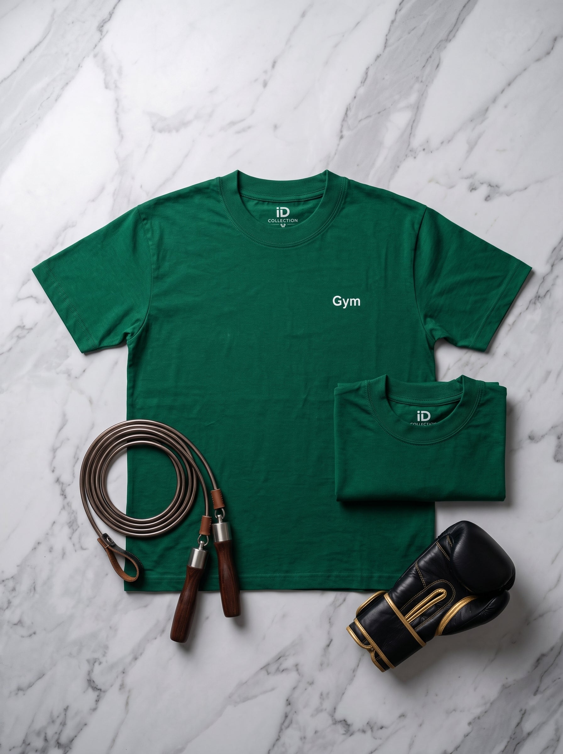 Gym Tee — forest green t-shirt flat lay with jump rope and boxing gloves on marble