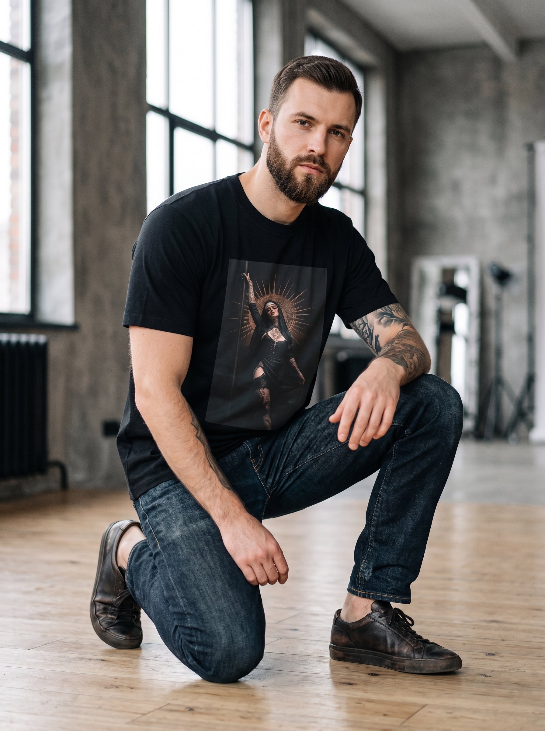 Dark Saint Tee — black t-shirt with dark saint halo woman graphic worn by tattooed man in loft