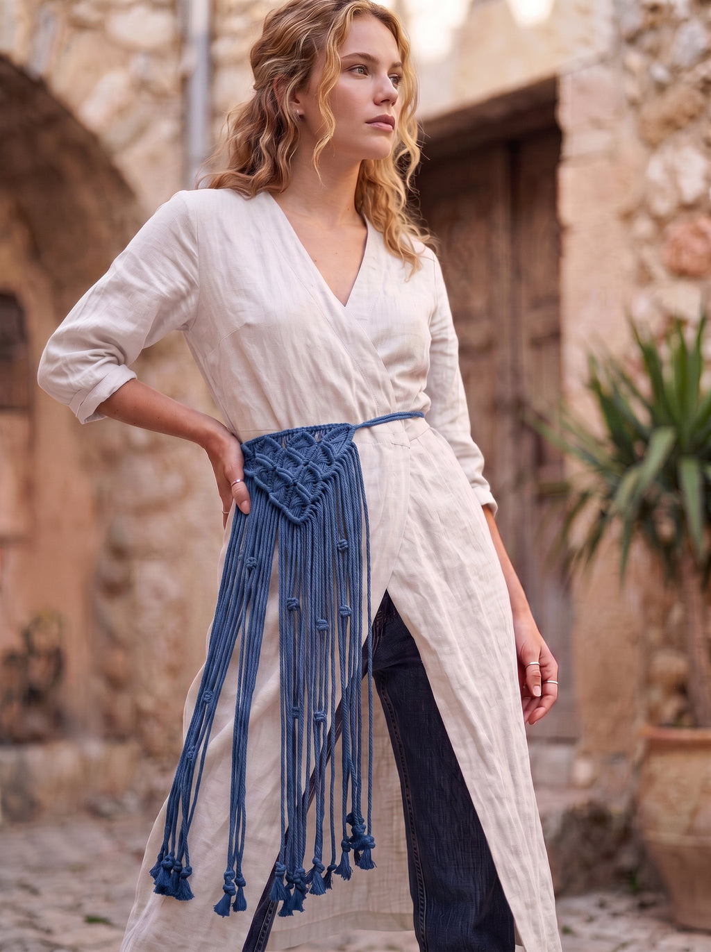 Macrame Fringe Belt in Navy Blue — worn by model over white dress in Mediterranean setting
