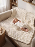 Chunky Knit Baby Blanket in Cream — baby sleeping on hand-knitted chunky blanket on armchair