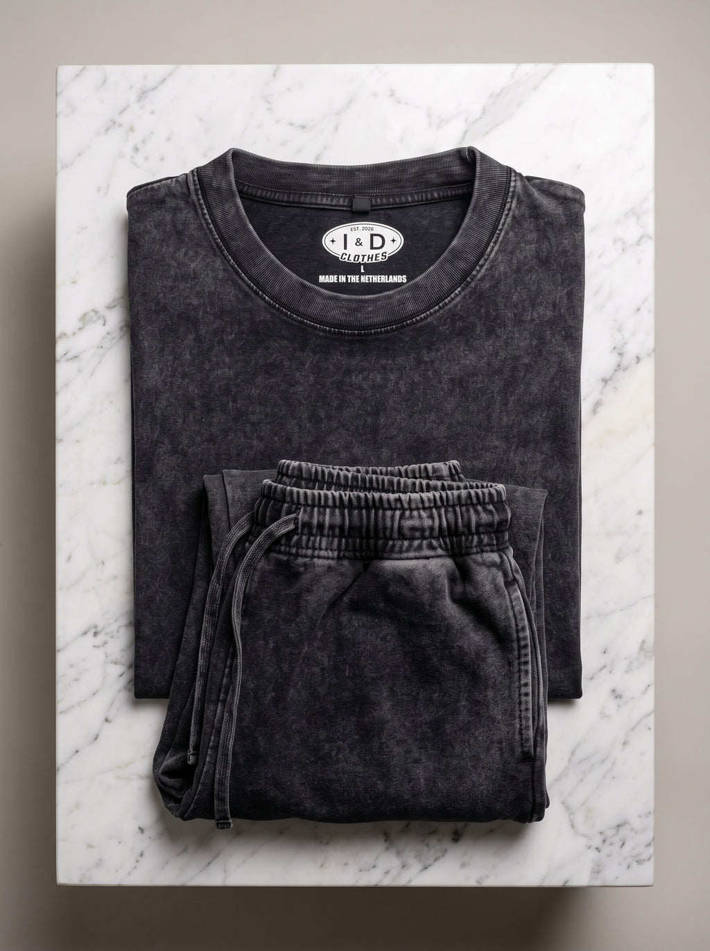 I&D Acid Wash Tank & Shorts Set — folded set on marble surface, dark charcoal acid wash, I&D Clothes label visible