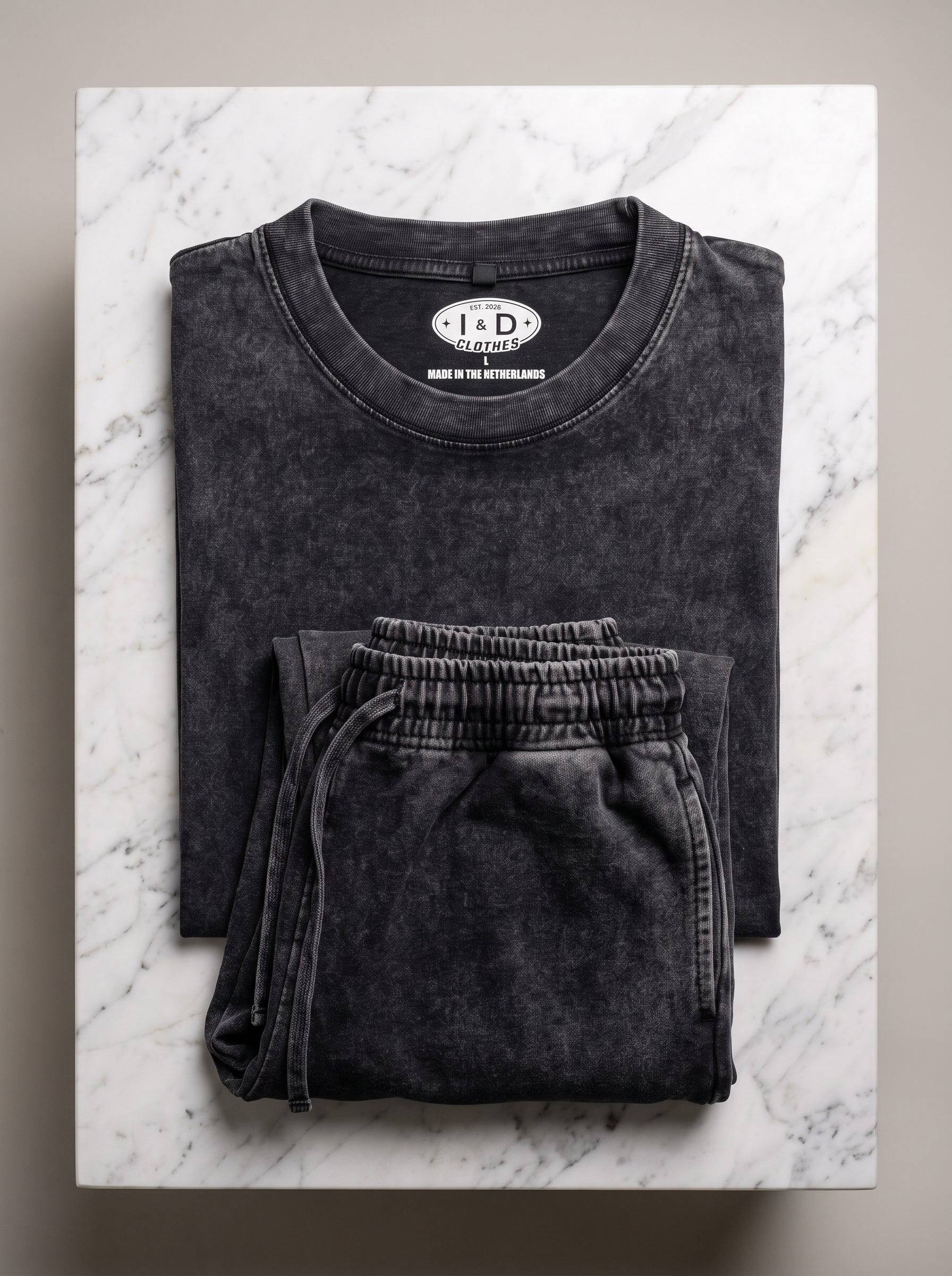 I&D Acid Wash Tank & Shorts Set — folded set on marble surface, dark charcoal acid wash, I&D Clothes label visible
