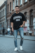 Kharkiv 1654 Tee — black oversized t-shirt worn by young man, street style