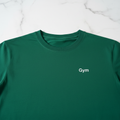 Gym Tee — close-up of white Gym print on forest green t-shirt