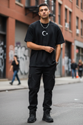 Crescent 46 Tee — front view on model, urban street