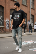 The Happy Face Tee worn by man on urban street